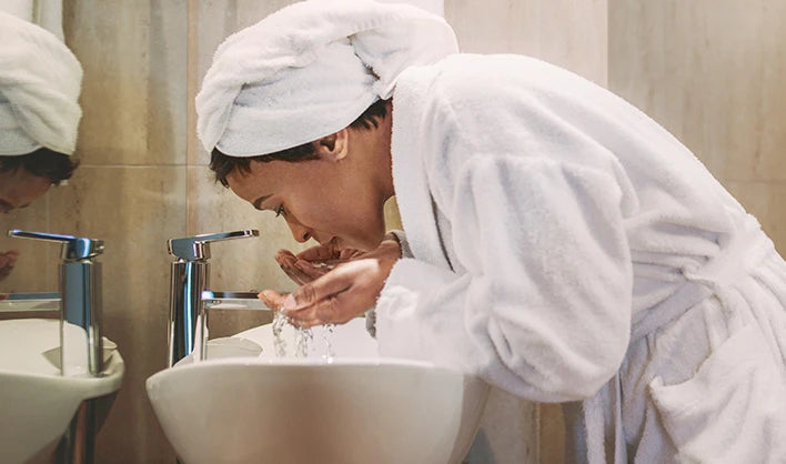 perimenopause woman takes time in the evening to use skin care products for menopause she found on Versalie.com