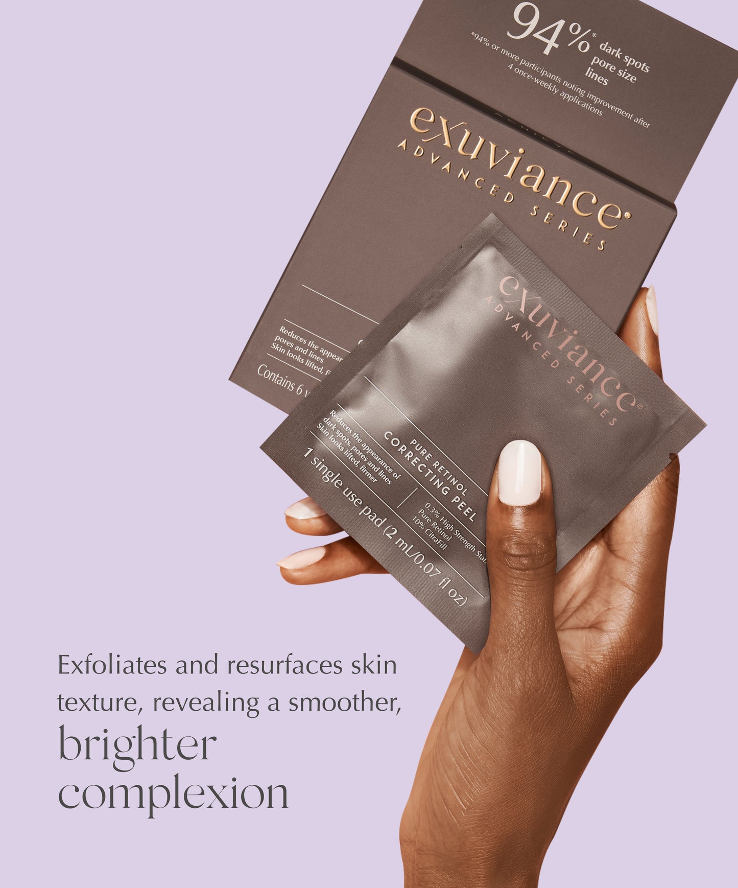 A women holding one box and one packet of Exuviance Pure Retinol Correcting Peels