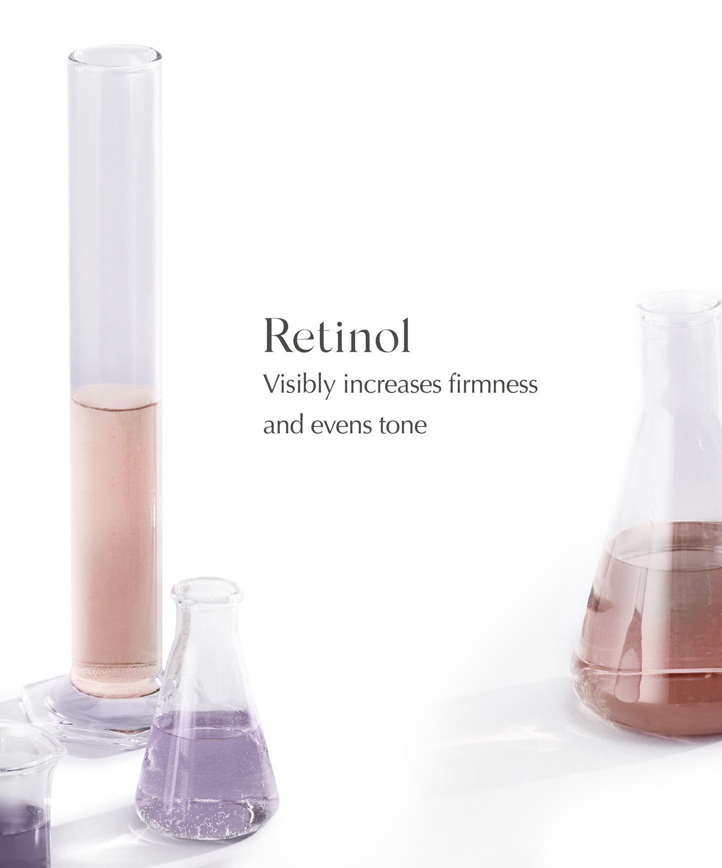 An assortment of beakers and test tubes with purple and pink liquid inside