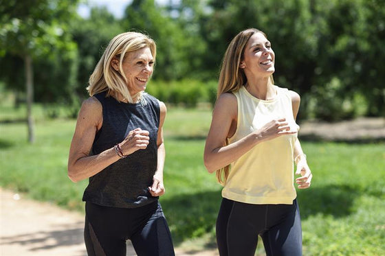 two women running in the park, discussing about how to stop hot flashes fast in summer during menopause 