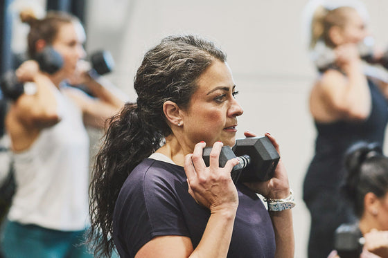 Group of women doing strength training to prevent bone loss, support bone health, and reduce the risk of hip fractures during and after menopause