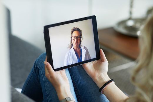 Woman meeting a menopause-trained clinician during a virtual telehealth visit to discuss her menopause symptoms