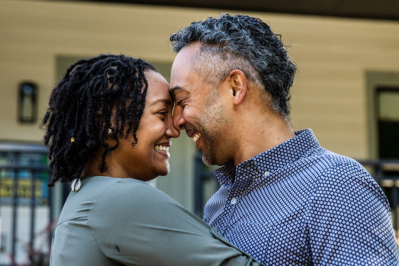 Close-up of two adults embracing outdoors, symbolizing intimacy and connection during midlife and menopause.
