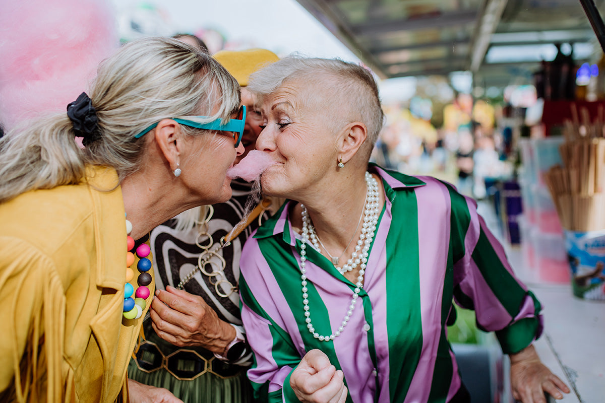 a couple at an outdoor fair connecting, rediscovering intimacy, and having fun postmenopause