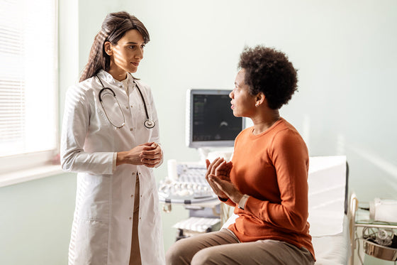 Woman in perimenopause meets with her doctor after learning how to prepare for an appointment and advocate for herself