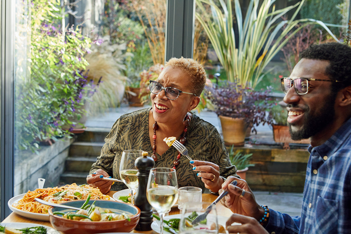 woman going through menopause has a meal with a man after fating to help ease menopause symptoms