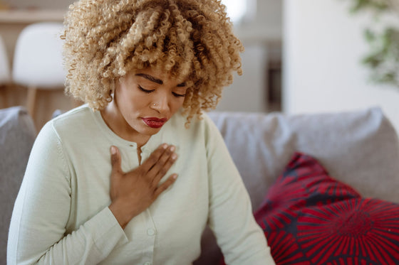 Woman going through menopause and heartburn