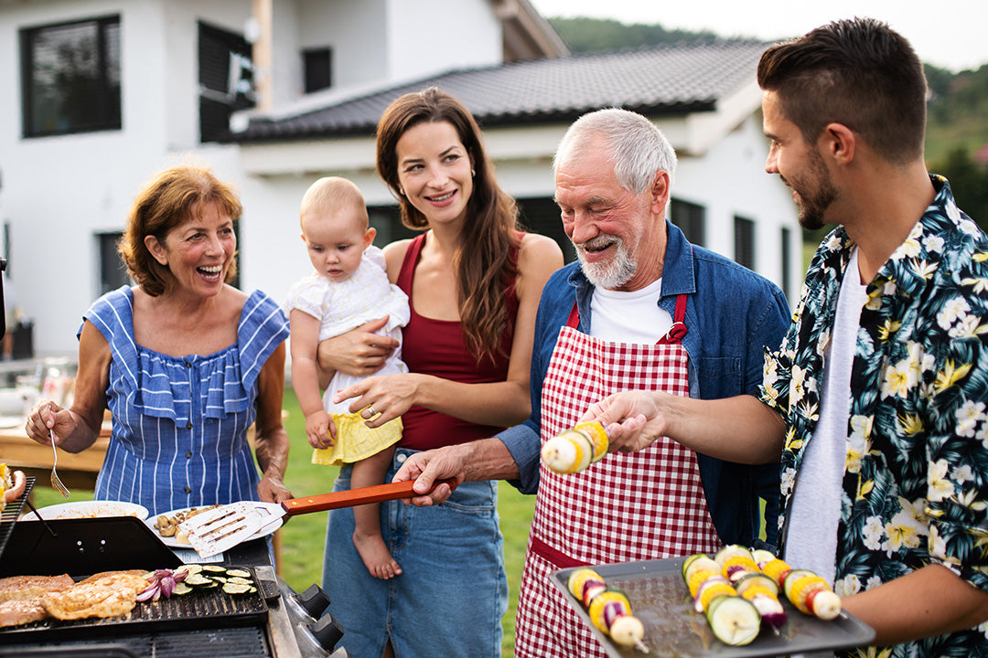 multigenerational family celebrating summer foods and grilling together
