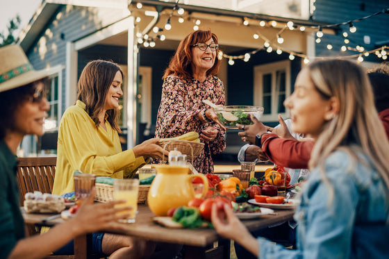 Group of friends enjoying an outdoor meal together, illustrating connection and support, key themes in challenging menopause misconceptions.