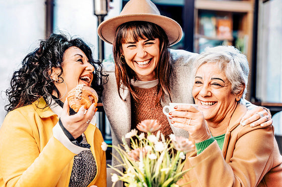 three women friends gathering together, sharing their thoughts about the unexpected benefits of friendship during menopause