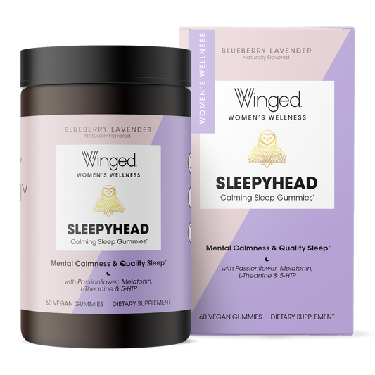 A container of Blueberry Lavender flavored Winged Wellness Sleepyhead Sleep + Stress Gummies next to the box
